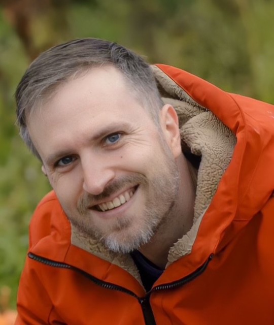 Portrait of a smiling man in an orange jacket